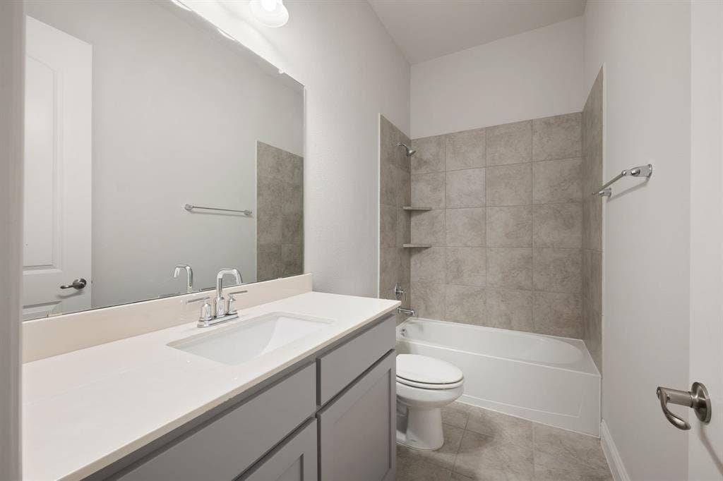 White vanity with a single basin sink, chrome faucet, and integrated countertop
