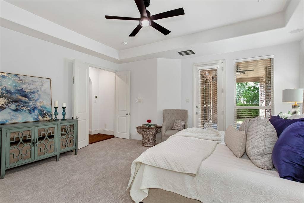 Tray ceiling with a ceiling fan, recessed lighting, and light-tone carpeting