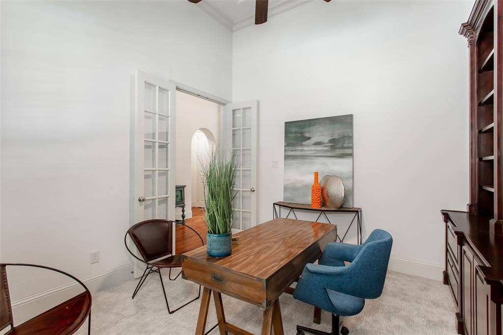 French doors with divided lites, tall ceilings, and carpet flooring