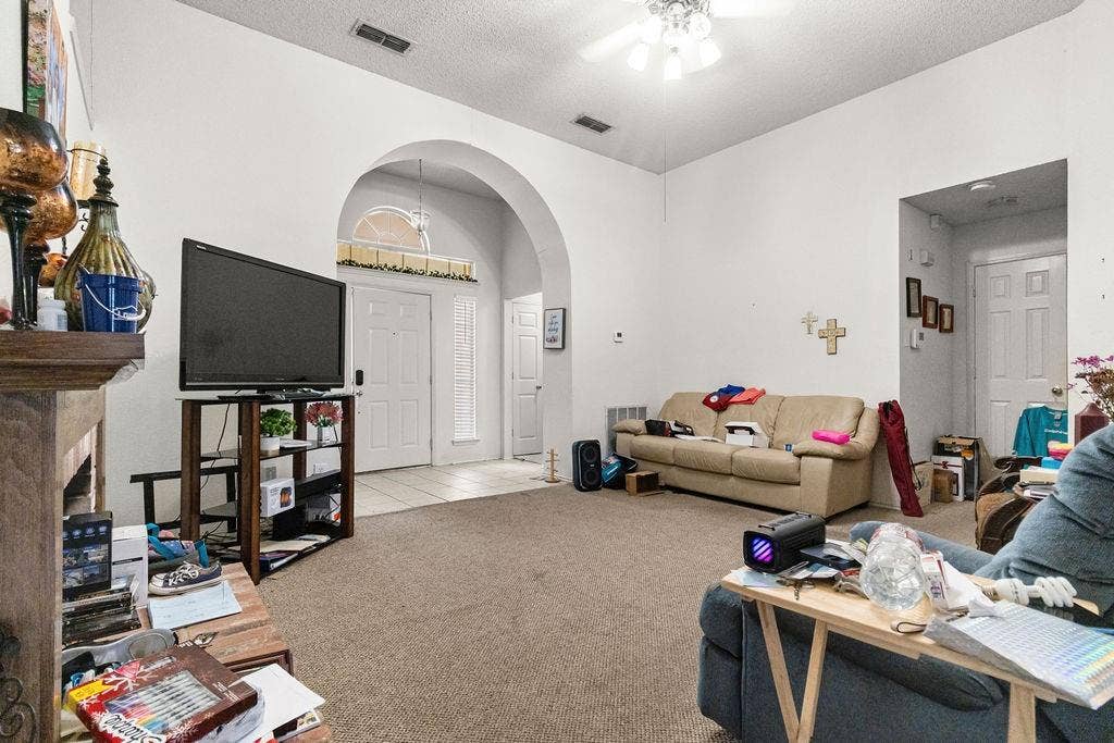 926 Wintercrest Court, Arlington, TX 76017 Arched entryway with transom window, ceiling fan, carpeted flooring, and white interior doors