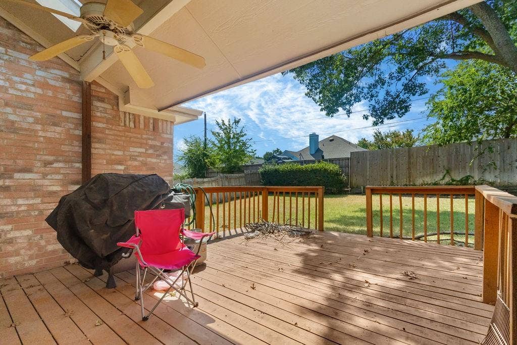 926 Wintercrest Court, Arlington, TX 76017 Covered patio featuring a ceiling fan, wood-finish decking, and a brick exterior wall