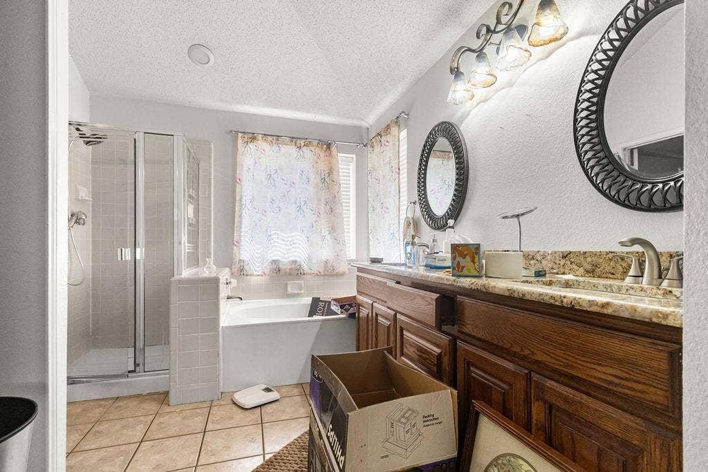 926 Wintercrest Court, Arlington, TX 76017 Dual vanity with undermount sinks, tile flooring, glass-enclosed shower, and built-in tub