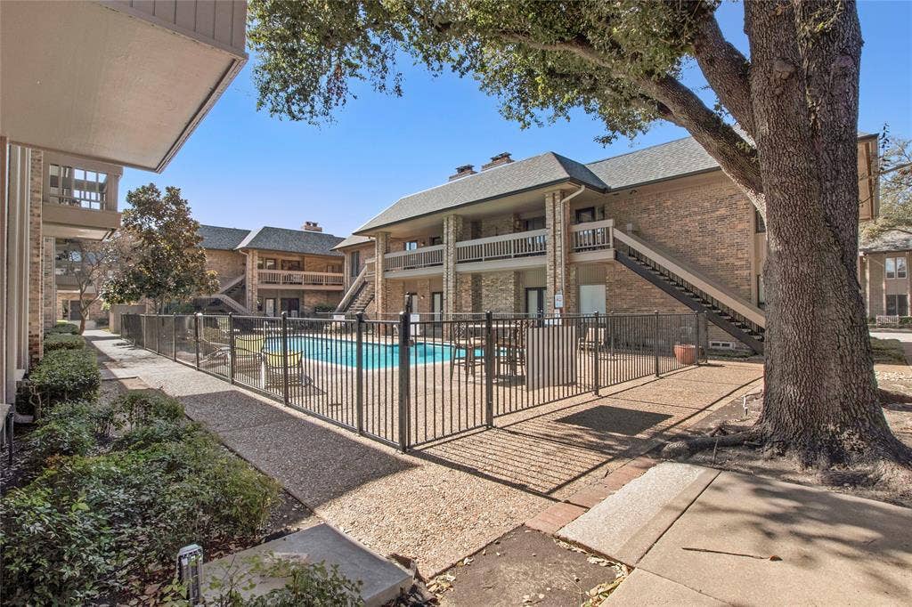 Community pool featuring stairway and a patio