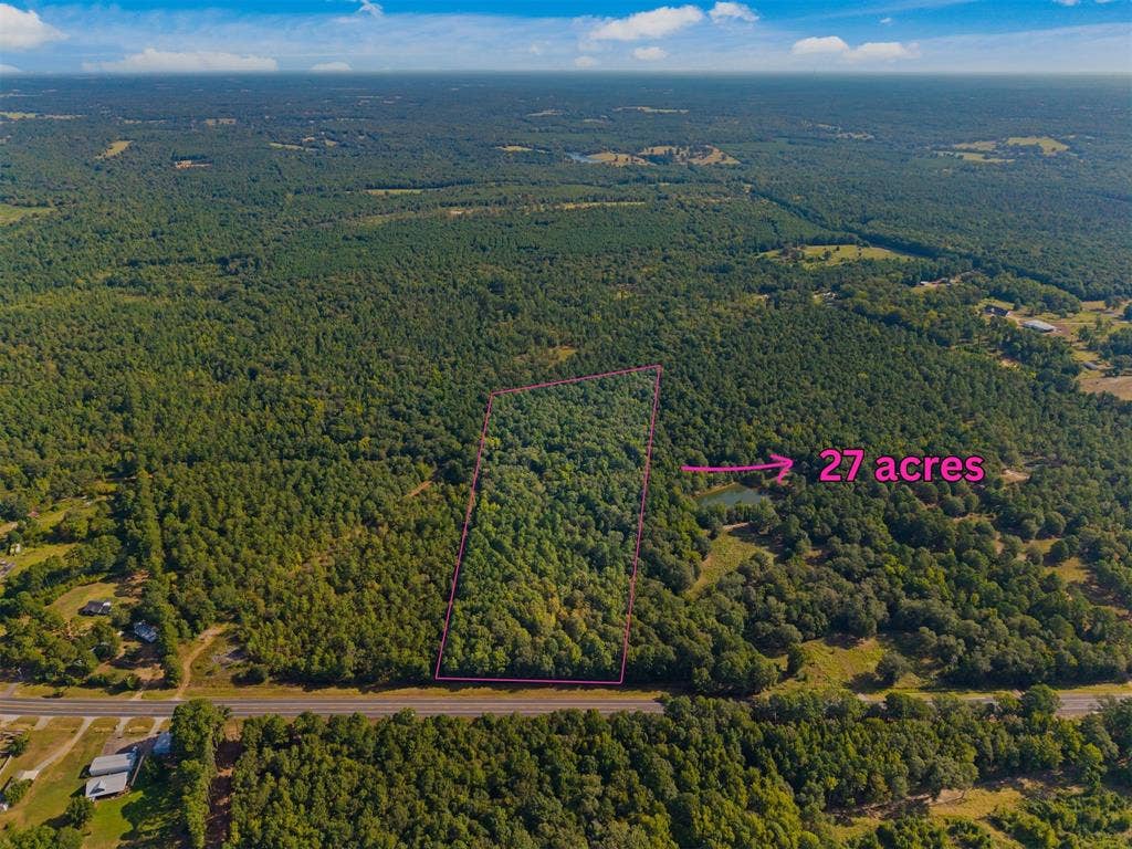 23791 State Highway 64 E, Troup, TX 75789 Expansive 27-acre parcel featuring mature tree coverage and a natural pond