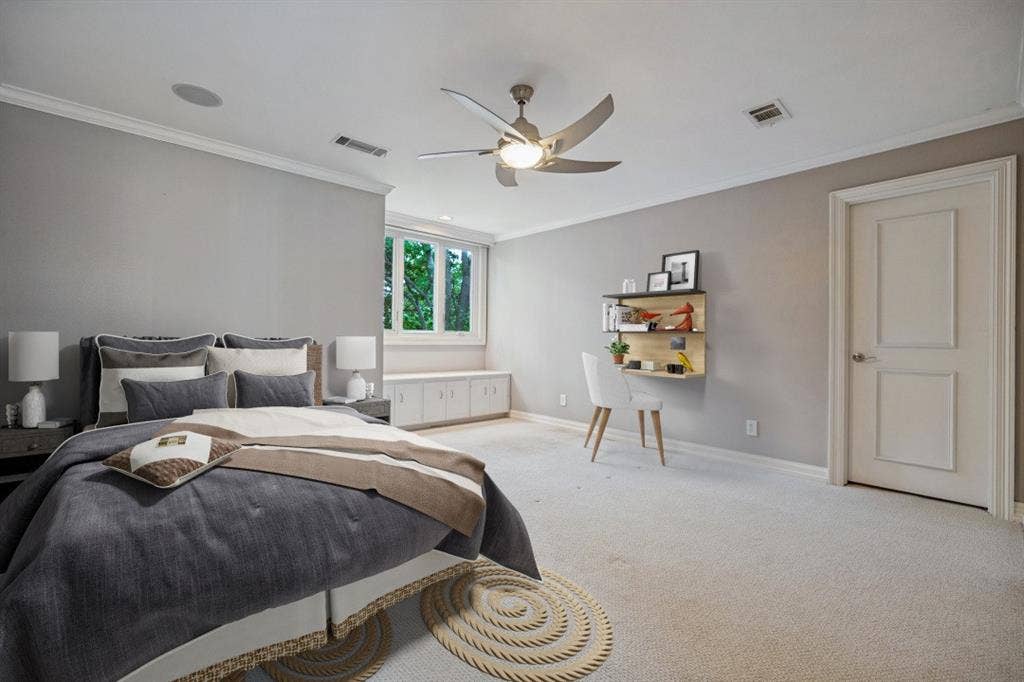 Recessed lighting, crown molding, ceiling fan with integrated lighting, built-in window seating with storage, and paneled interior door (this photo is virtually staged)