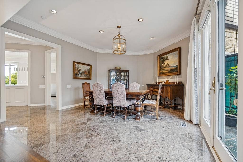 Recessed lighting, crown molding, and marble flooring