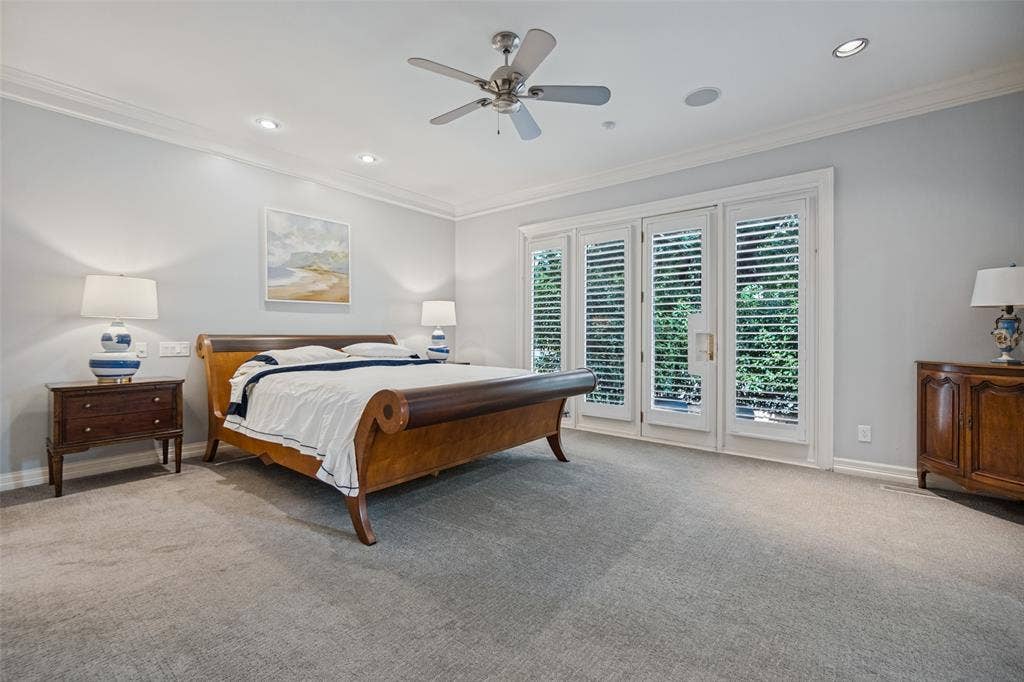 Downstair primary bedroom with recessed lighting, crown molding, ceiling fan, carpet flooring, and white plantation shutters