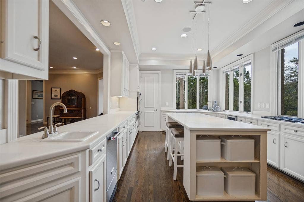 White cabinetry, recessed lighting, and wood-finish flooring