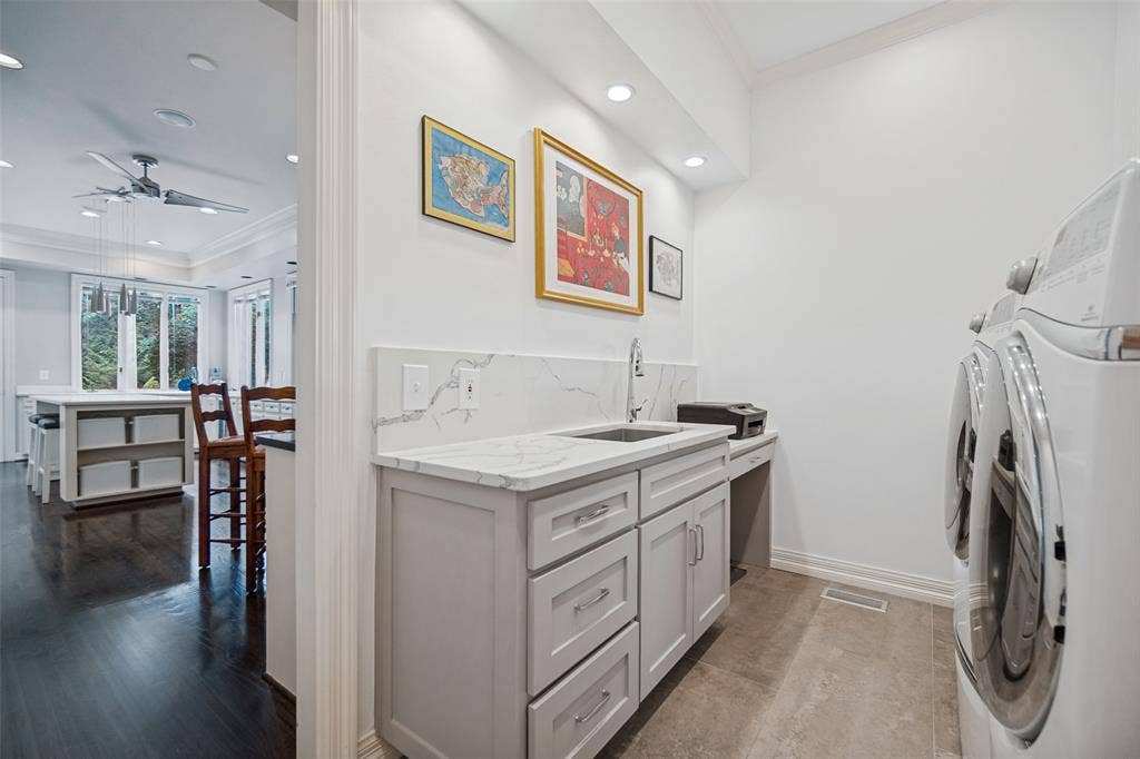 Laundry area featuring white walls, recessed lighting, and a utility sink