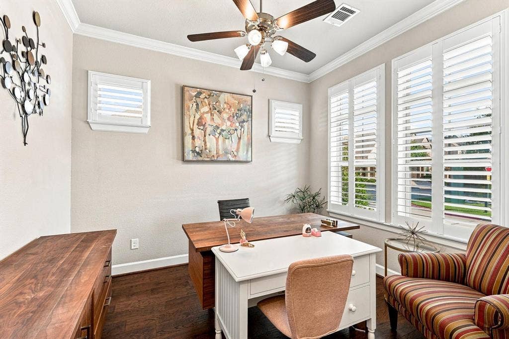 5441 Caine Road, Richardson, TX 75082 Dark wood-finish flooring, crown molding, and multiple windows with plantation shutters