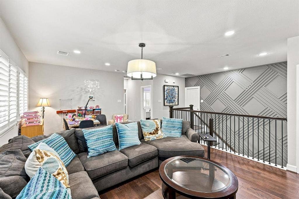5441 Caine Road, Richardson, TX 75082 Hardwood-finish flooring, recessed lighting, and a decorative accent wall featuring geometric paneling