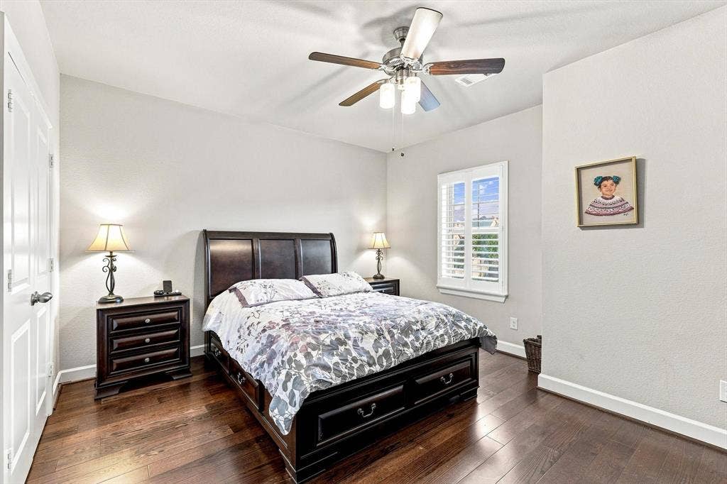 5441 Caine Road, Richardson, TX 75082 Hardwood flooring, window with plantation shutters, ceiling fan, and white painted walls