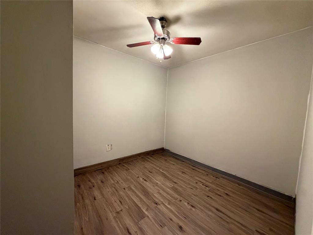 Wood-finish flooring with a ceiling fan light fixture