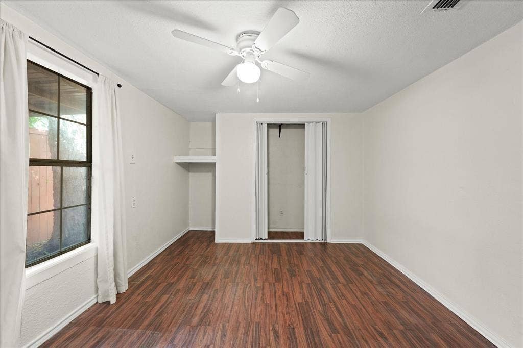 709 S Munger Boulevard, Dallas, TX 75223 Wood-finish flooring, ceiling fan with integrated lighting, built-in shelving, and bifold closet doors