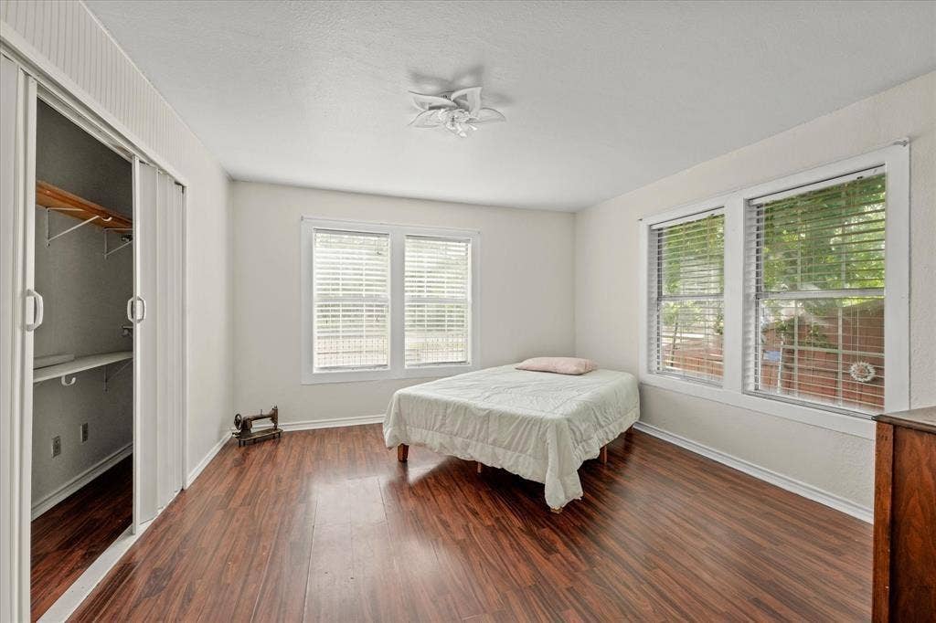 709 S Munger Boulevard, Dallas, TX 75223 Wood-finish flooring, white walls, and multiple windows with blinds