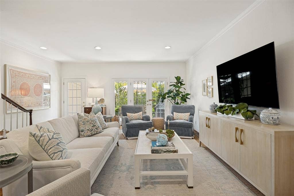 7526 W Northwest Highway, #5, Dallas, TX 75225 Living room with can lights and hardwood floors overlooks private patio. Great natural light throughout.