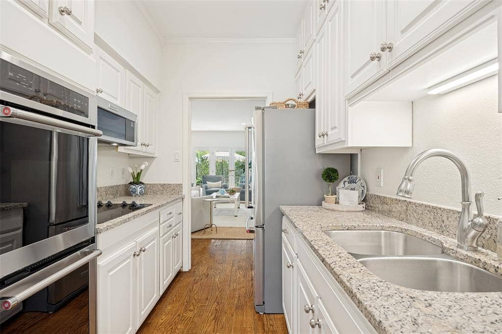 7526 W Northwest Highway, #5, Dallas, TX 75225 Galley kitchen leads to large living area.