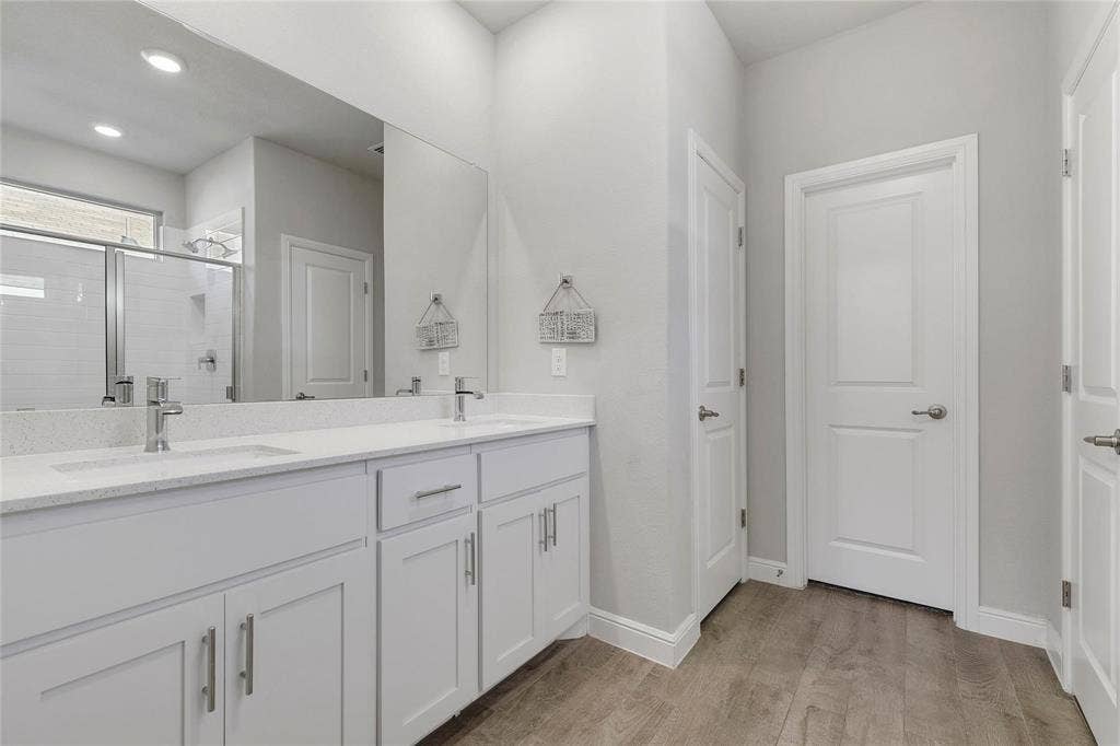 821 Shepperton Way, Fort Worth, TX 76247 Bathroom featuring walk in shower, vanity, and hardwood / wood-style flooring
