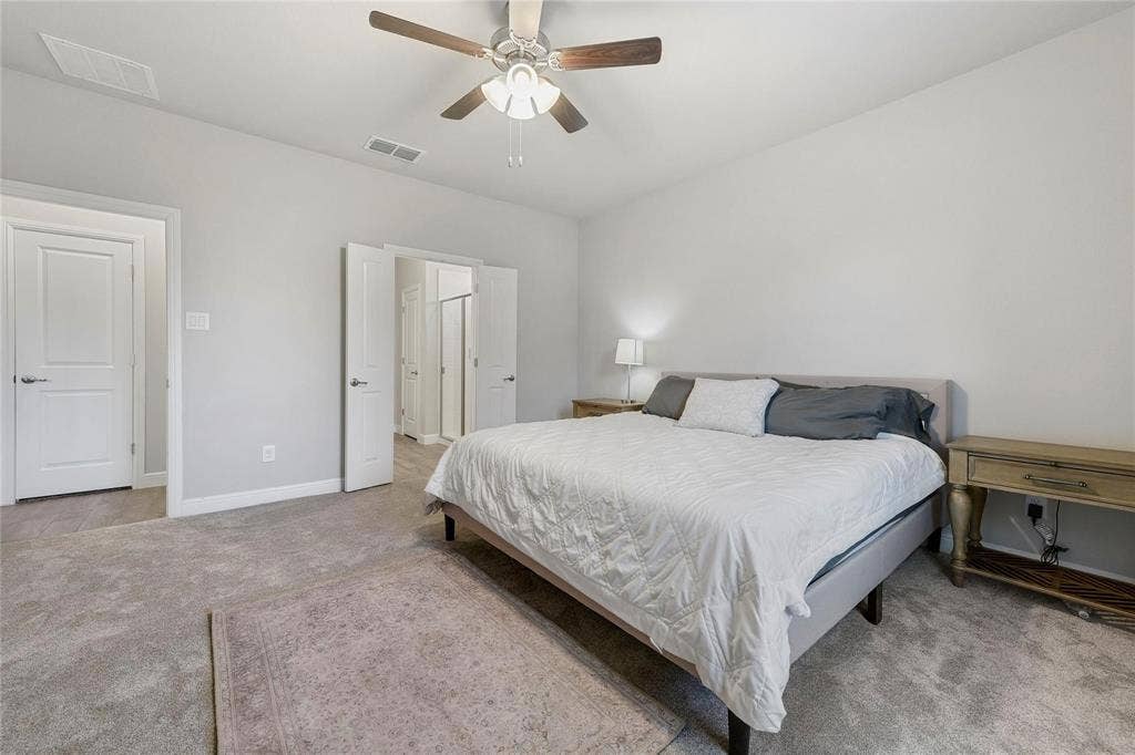 821 Shepperton Way, Fort Worth, TX 76247 Bedroom with light carpet and ceiling fan