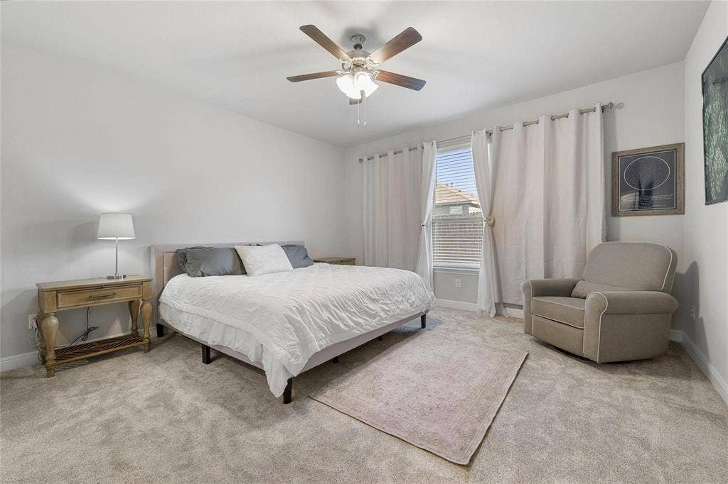 821 Shepperton Way, Fort Worth, TX 76247 Bedroom with light colored carpet and ceiling fan