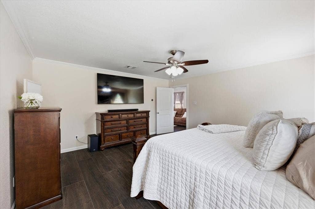 2225 Torch Lake Drive, Forney, TX 75126 Wood-finish flooring, crown molding, and a ceiling fan with light fixture