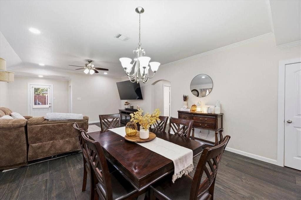 2225 Torch Lake Drive, Forney, TX 75126 Open-concept dining and living areas with wood-finish flooring, recessed lighting, and a chandelier