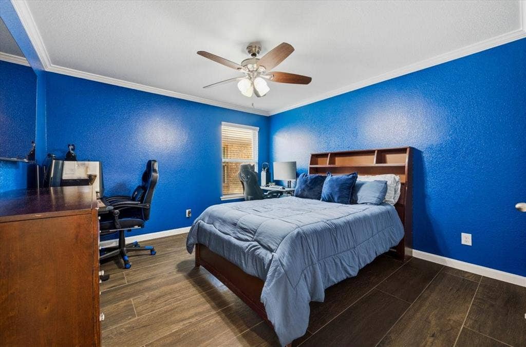 2225 Torch Lake Drive, Forney, TX 75126 Wood-finish flooring, crown molding, built-in shelving, ceiling fan, and recessed window