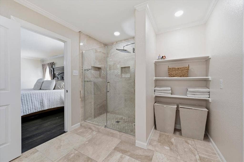 2225 Torch Lake Drive, Forney, TX 75126 Walk-in shower with glass enclosure, tiled walls, and built-in niches