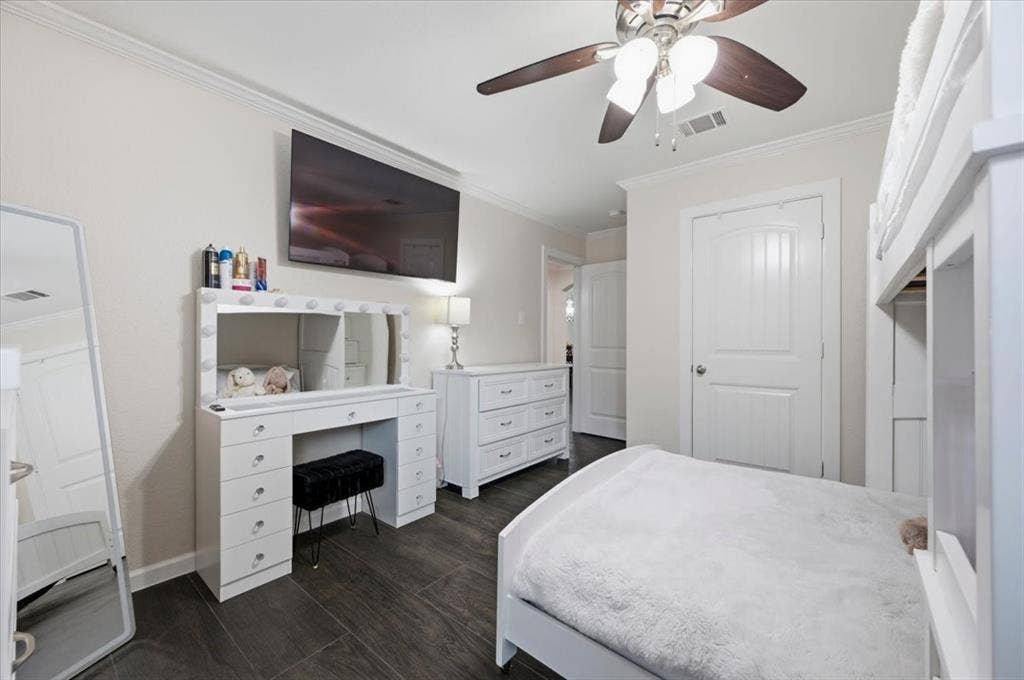 2225 Torch Lake Drive, Forney, TX 75126 Dark-toned wood-finish flooring complements light-toned walls and crown molding