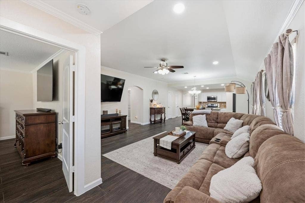 2225 Torch Lake Drive, Forney, TX 75126 Wood-finish flooring, recessed lighting, arched doorway, ceiling fan, and crown molding