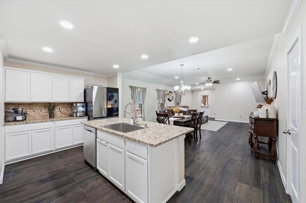 2225 Torch Lake Drive, Forney, TX 75126 White cabinetry with integrated stainless steel appliances, granite countertops, and a tile backsplash