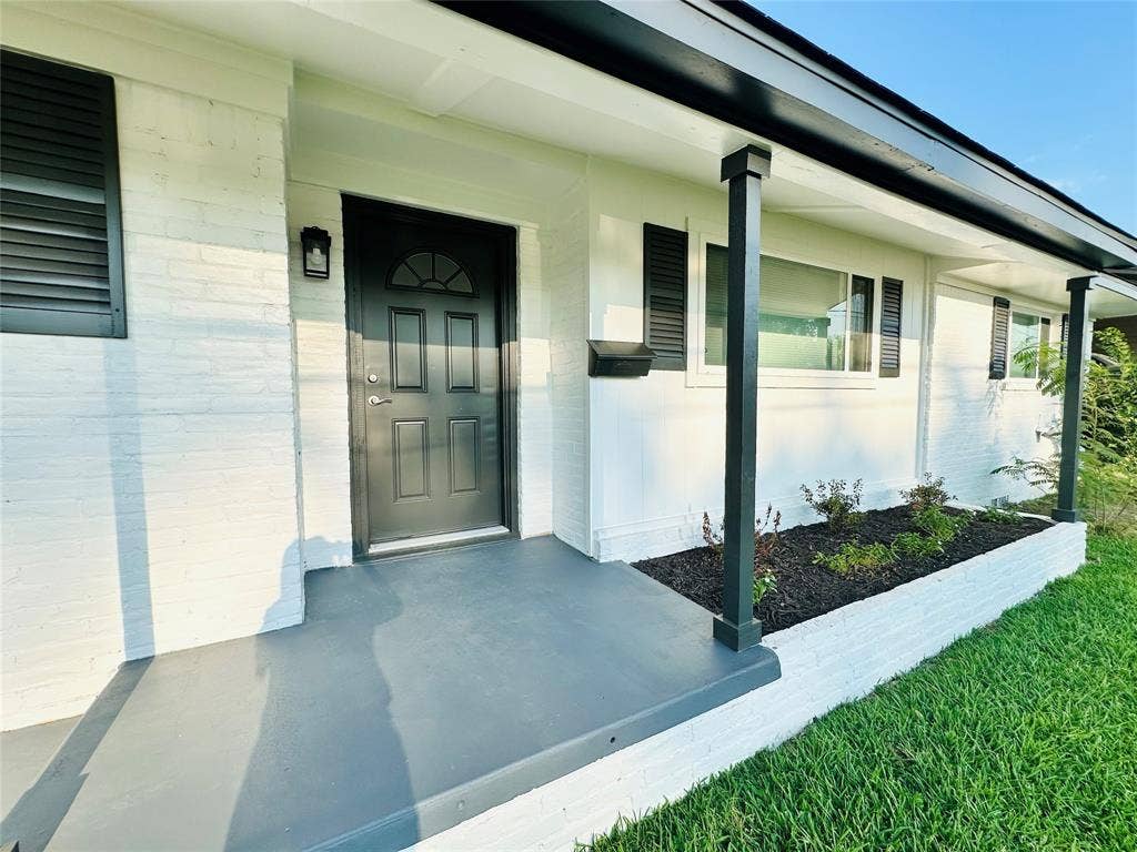 White brick exterior with dark trim accents