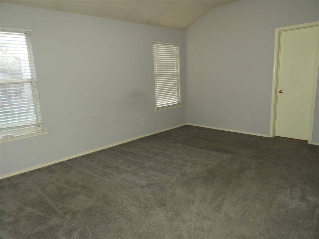 Primary Bedroom with lots of light, vaulted ceilings and brand new ceiling fan.