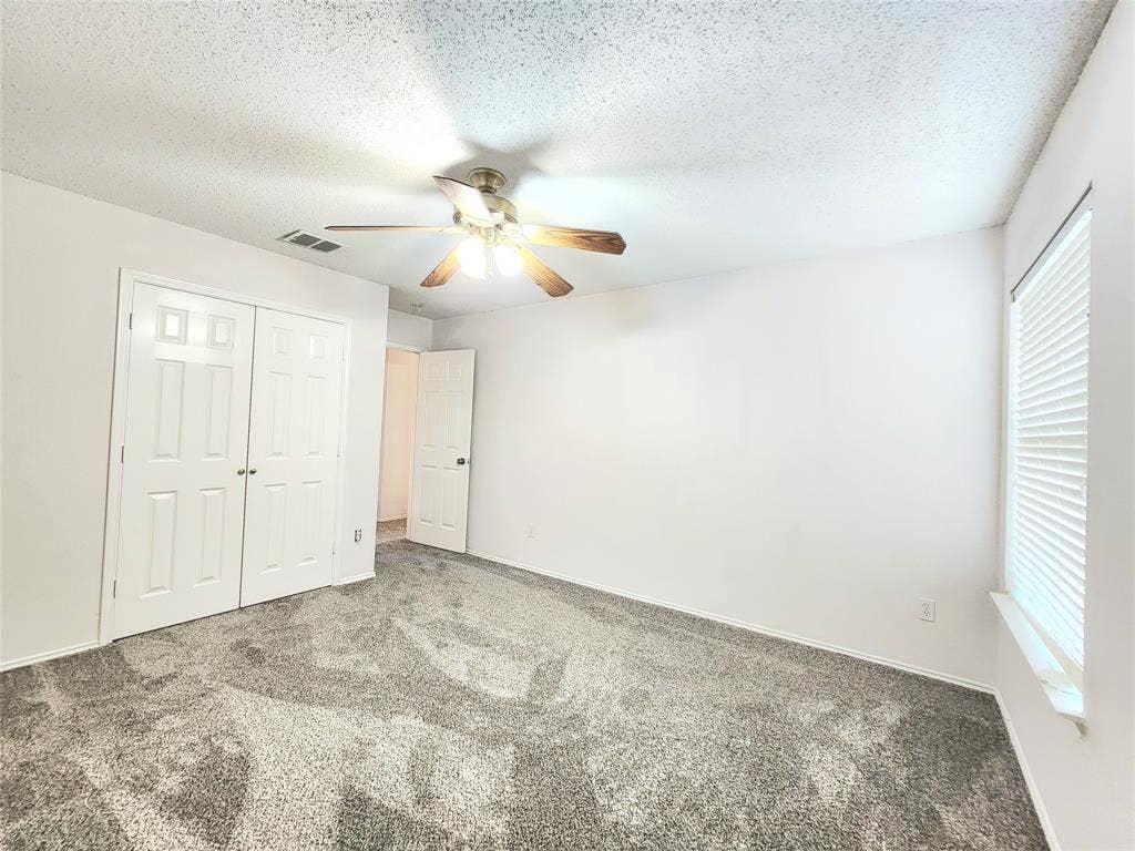 3625 Mason Drive, Plano, TX 75025 Textured ceiling with a ceiling fan light fixture, white walls, and gray patterned carpeting