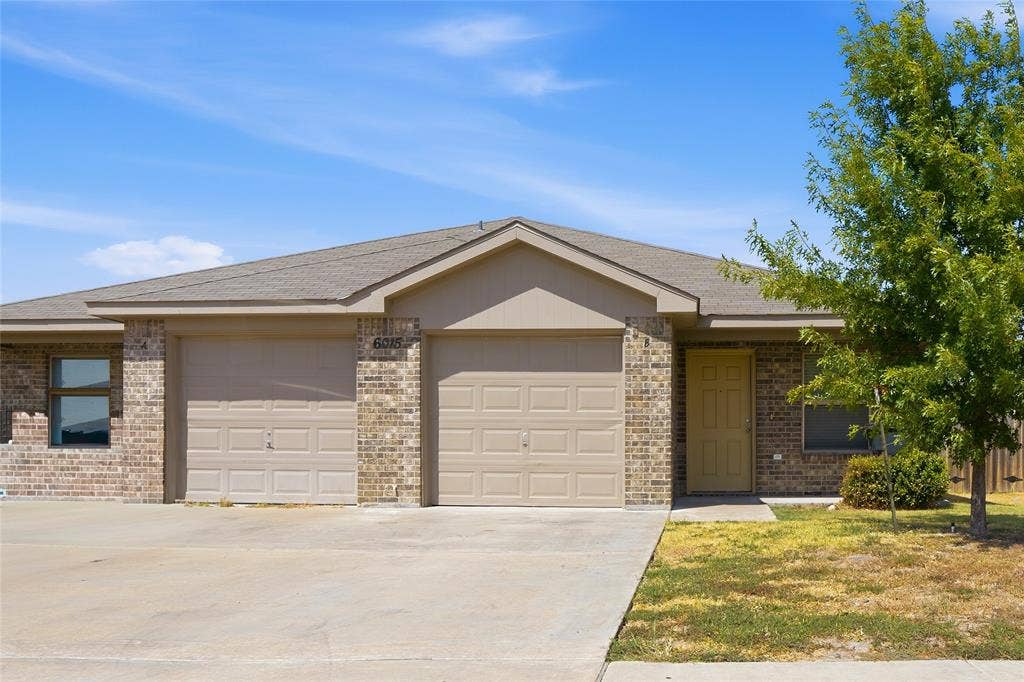 6015 Amelia Earhart Boulevard, #B, Killeen, TX 76543 Brick exterior with a gabled roof and attached two-car garage