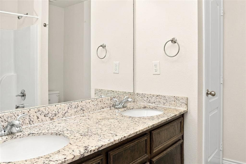 6015 Amelia Earhart Boulevard, #B, Killeen, TX 76543 Dual vanity with granite countertops, undermount sinks, and chrome faucets