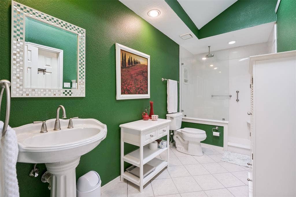 Pedestal sink with brushed nickel faucet, walk-in shower with glass enclosure, white square tile flooring, and recessed lighting