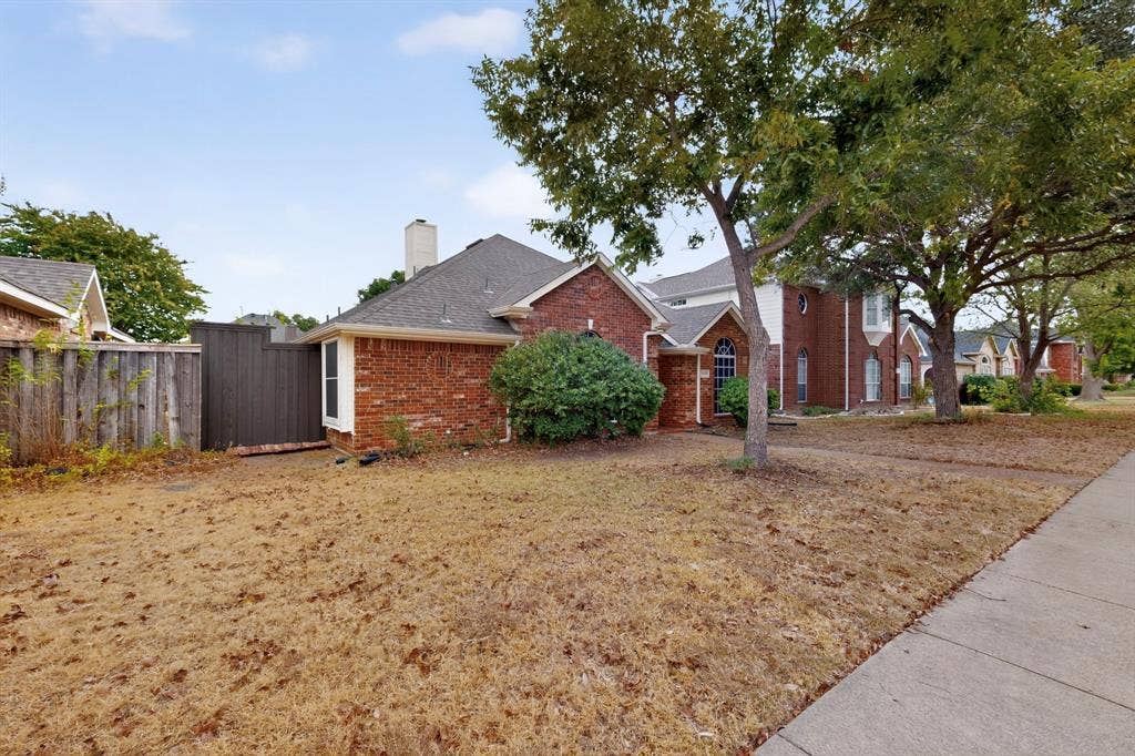 8108 Case Drive, Plano, TX 75025 Red brick exterior with white trim, arched window, and a gabled roof