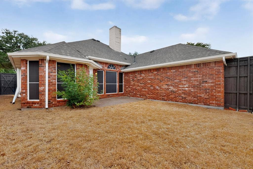 8108 Case Drive, Plano, TX 75025 Brick exterior with a shingle roof and white gutters