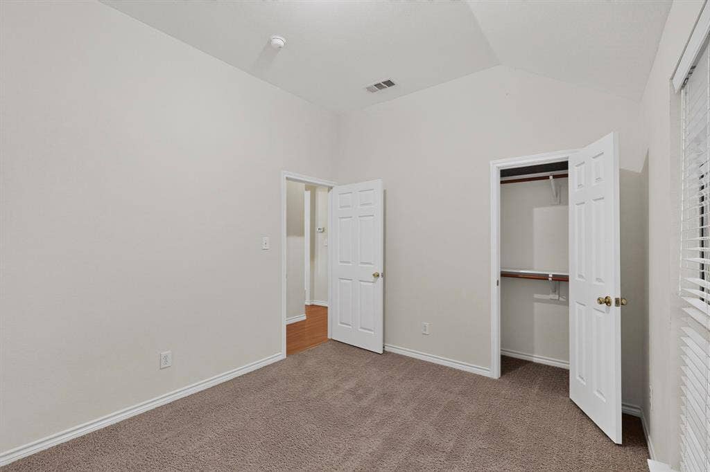 8108 Case Drive, Plano, TX 75025 Vaulted ceilings, paneled doors, textured carpeting, and a built-in closet with wood shelving and a hanging rod