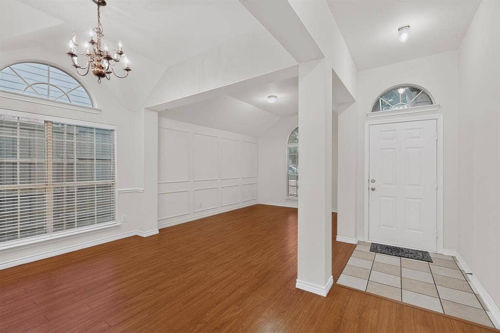 8108 Case Drive, Plano, TX 75025 Entryway featuring a tiled landing, arched transom window, and wood-finish flooring