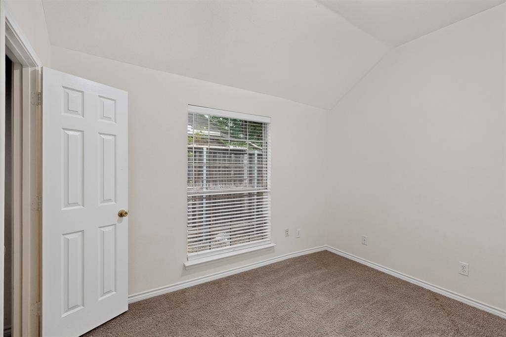8108 Case Drive, Plano, TX 75025 Angled ceiling, single window with blinds, six-panel interior door, wall-to-wall carpeting, and neutral wall tones