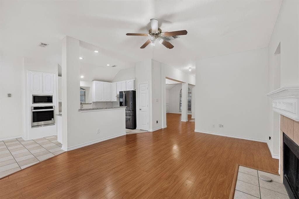 8108 Case Drive, Plano, TX 75025 Wood-finish flooring, recessed lighting, and a fireplace with a decorative mantel
