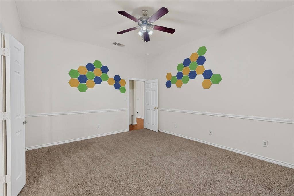 8108 Case Drive, Plano, TX 75025 Carpeted flooring, vaulted ceiling, ceiling fan, white paneled doors, and wainscoting