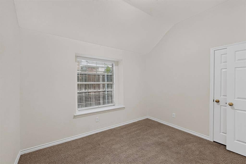 8108 Case Drive, Plano, TX 75025 Vaulted ceiling, neutral wall paint, window with blinds, carpeted flooring, and a bifold closet door