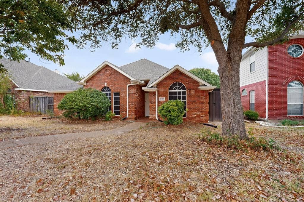 8108 Case Drive, Plano, TX 75025 Brick exterior with arched windows, prominent gables, and a mature shade tree