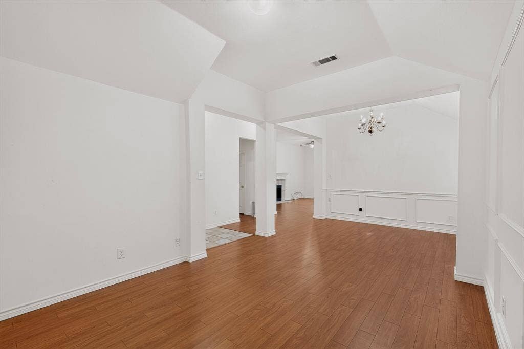8108 Case Drive, Plano, TX 75025 Wood-finish flooring, vaulted ceilings, wainscoting, and a chandelier