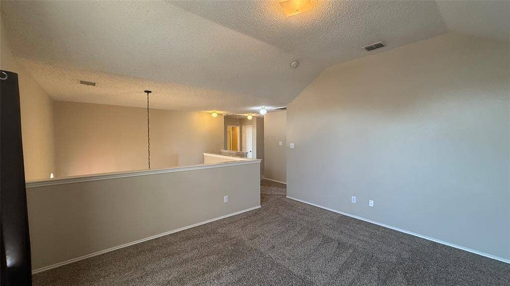 1433 Winterwood Drive, Allen, TX 75002 Carpeted flooring, vaulted ceiling, neutral wall tones, interior railing, and overhead lighting