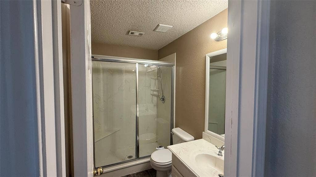 1433 Winterwood Drive, Allen, TX 75002 Bathroom featuring a shower with sliding glass doors, built-in shelving, and an integrated bench