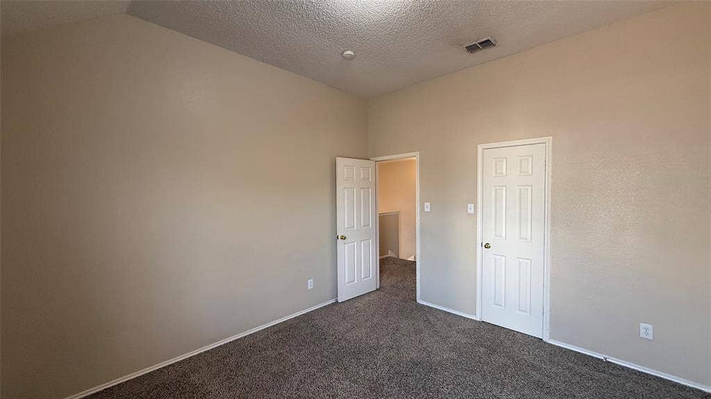 1433 Winterwood Drive, Allen, TX 75002 Plush carpeting, neutral wall finishes, white six-panel doors, and a vaulted ceiling